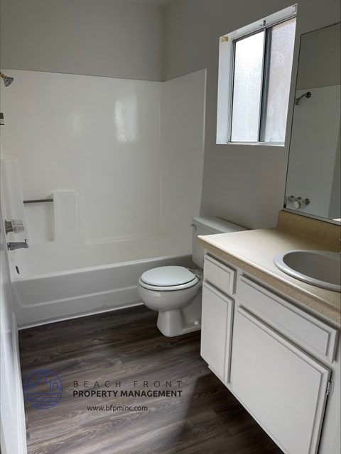 an empty bathroom with a toilet and a sink